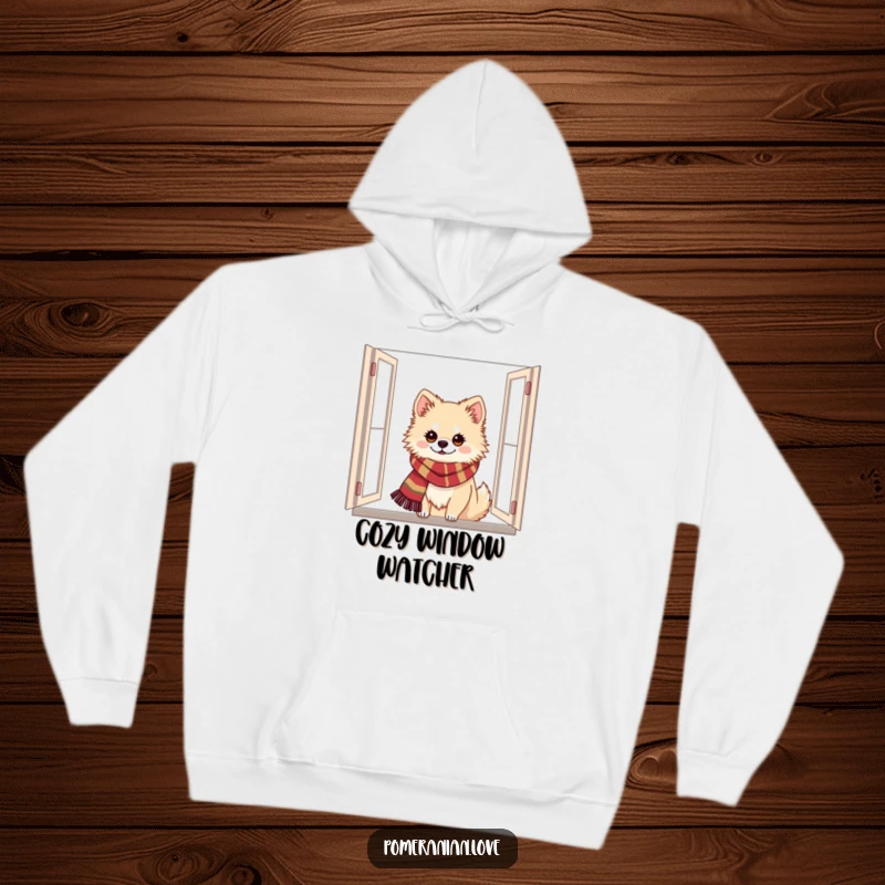 Funny Pomeranian hoodie featuring a dog with a festive scarf peeking from a window, radiating holiday comfort and joy.