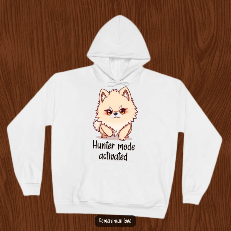 Funny Pomeranian dog character with a determined gaze, ready to pounce, embodying focus in this comfortable hoodie design.