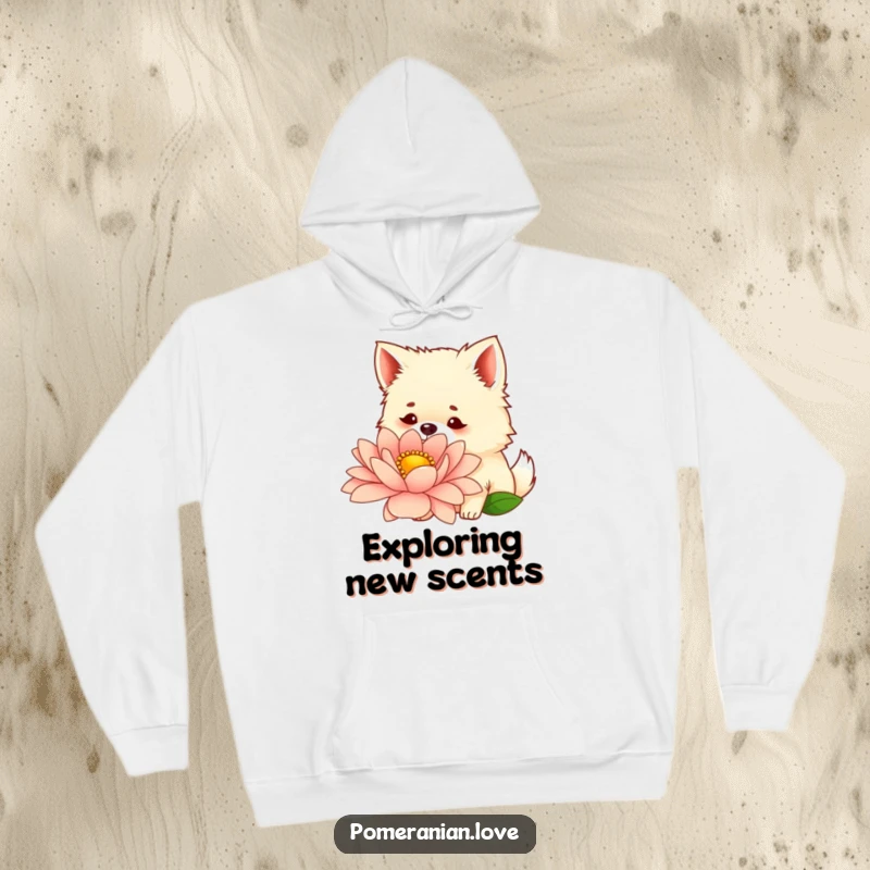 Funny hoodie showing a curious Pomeranian with perked ears, sniffing a large, beautiful flower, ideal for outdoor lovers.