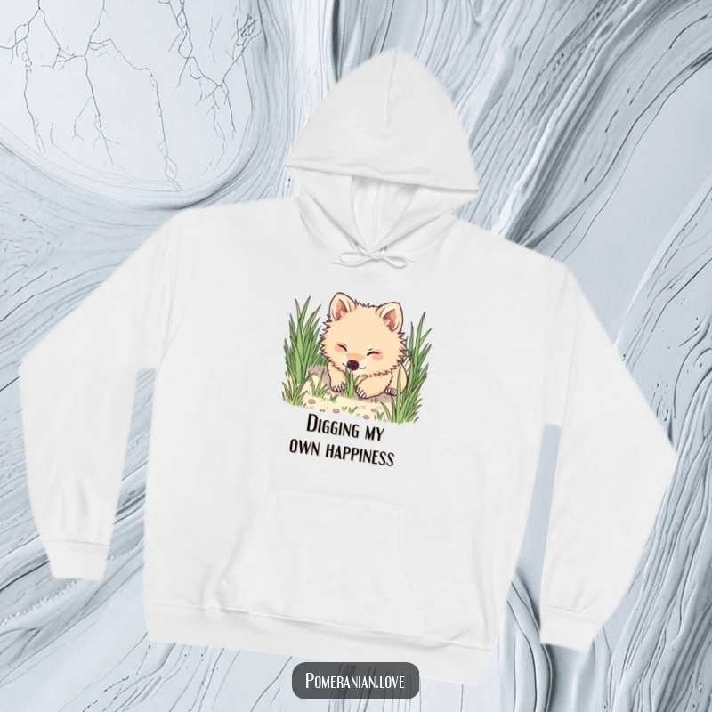 Funny Pomeranian hoodie featuring a happy dog digging its nose into soft grass, exuding pure, unadulterated playfulness.