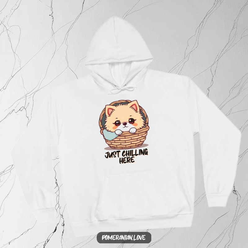Funny Pomeranian Hoodie: A Pomeranian with wide, expressive eyes peeking out from a cozy basket, radiating warmth, comfort, and adorable charm.
