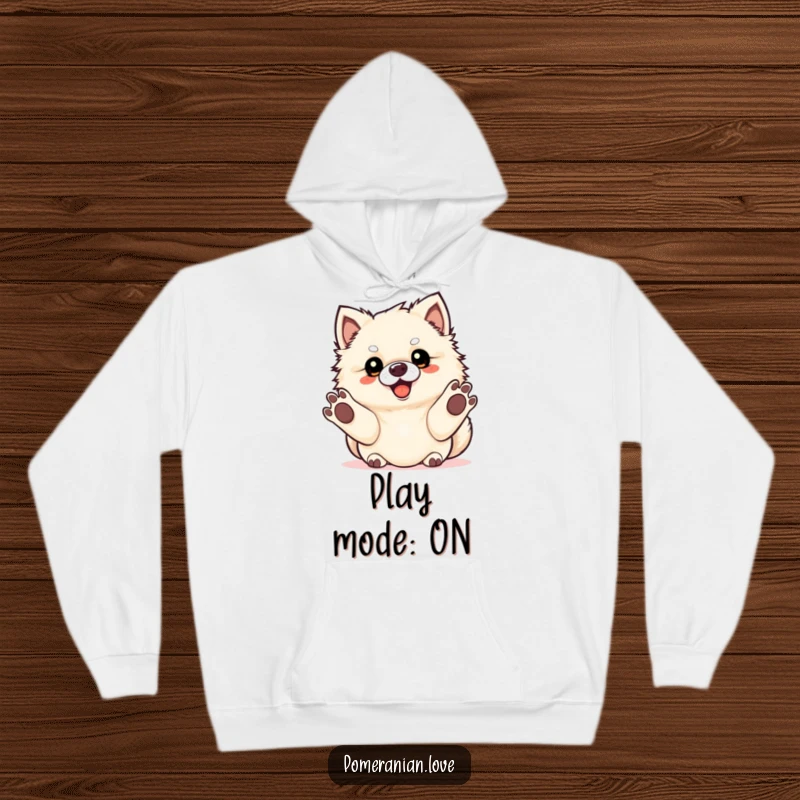 Funny Pomeranian dog with paws extended in anticipation of fetch, featured on a warm hoodie.