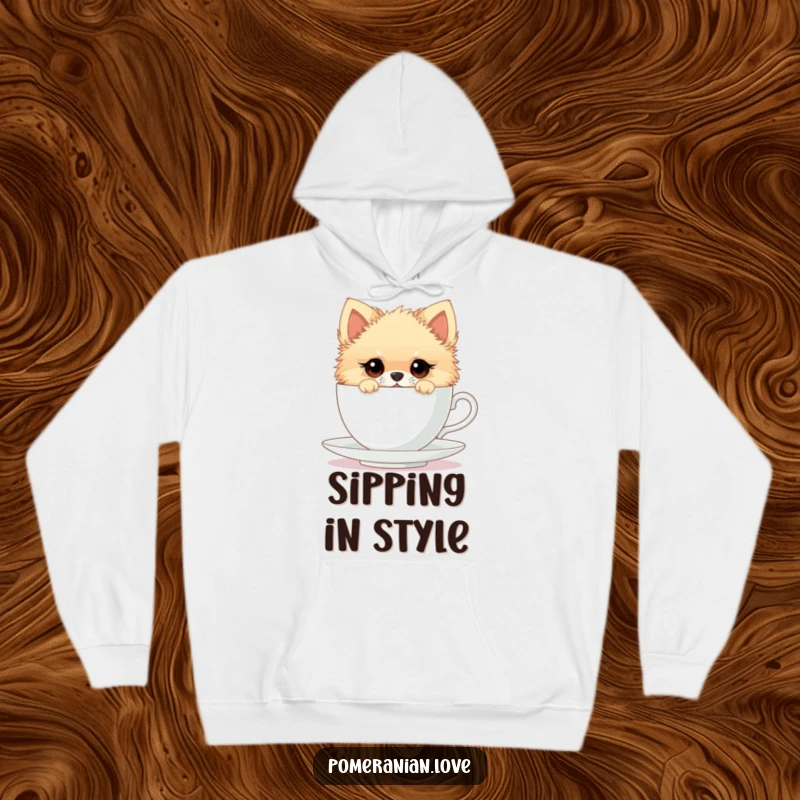 Funny hoodie featuring a Pomeranian with curious eyes peeking from an oversized teacup, perfect for cozying up with humor.