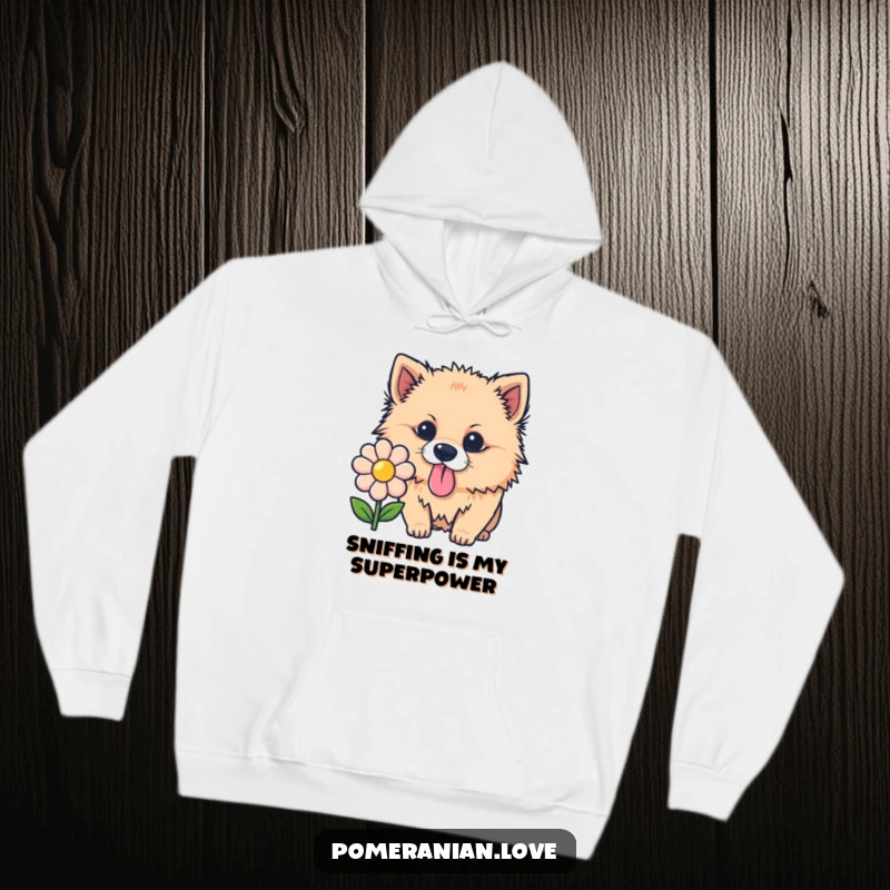Funny Pomeranian hoodie, a curious dog with tongue out sniffing a flower, cozy and humorous pet apparel.