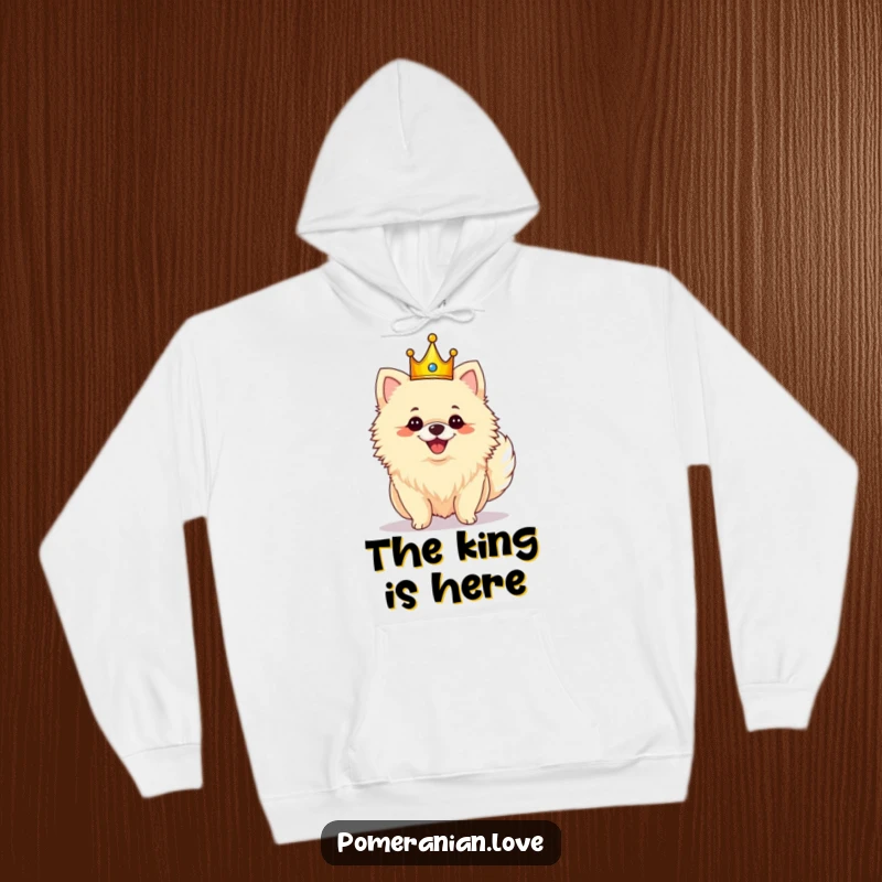Funny royal Pomeranian hoodie depicting a crowned dog shaking its fluffy tail with pure joy and glee.
