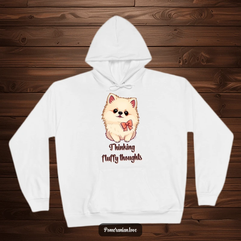 Funny Pomeranian hoodie featuring a dog wearing a tiny bow and tilting its head curiously, offering cozy charm and humor.
