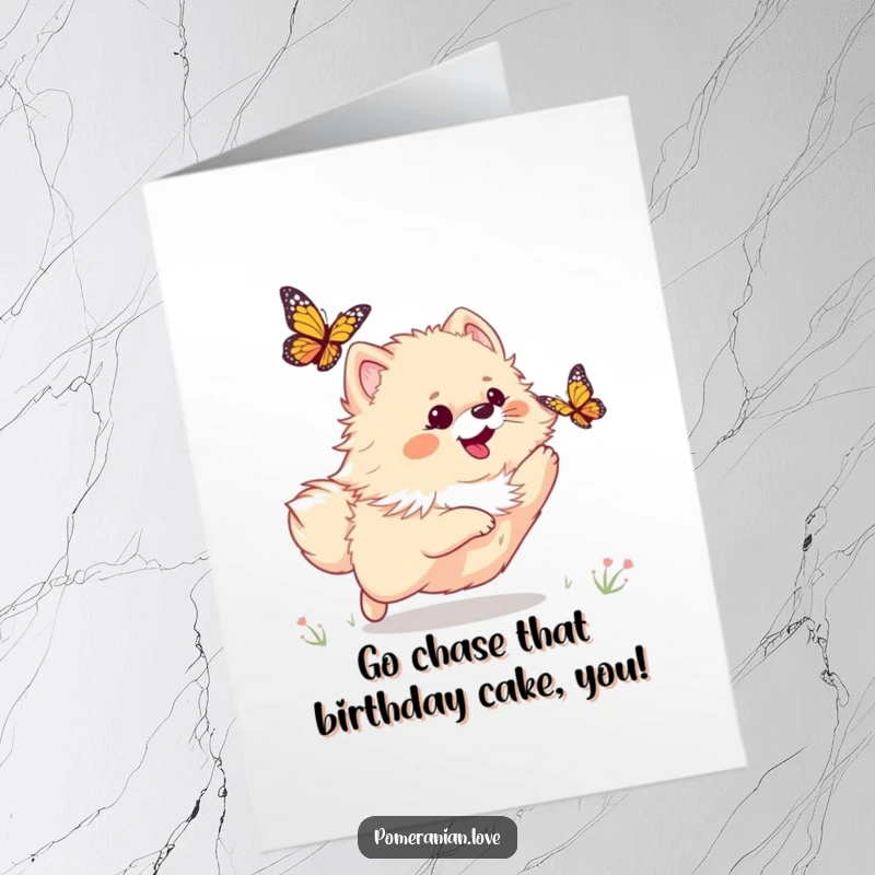 Funny Free Printable Birthday Card of a playful Pomeranian joyfully chasing a butterfly through a sunny meadow.