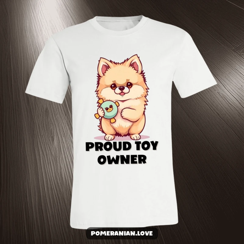 Funny Pomeranian T-shirt of a proud dog holding a squeaky toy, highlighting canine accomplishment and playtime.