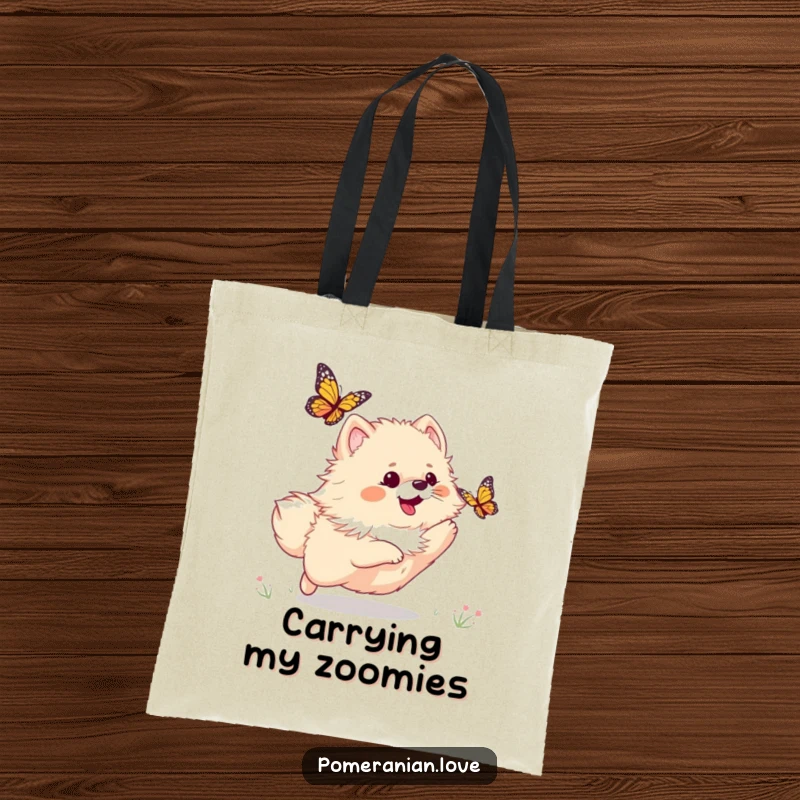 Funny tote bag featuring a playful Pomeranian dog chasing a butterfly, capturing a moment of pure, energetic fun.